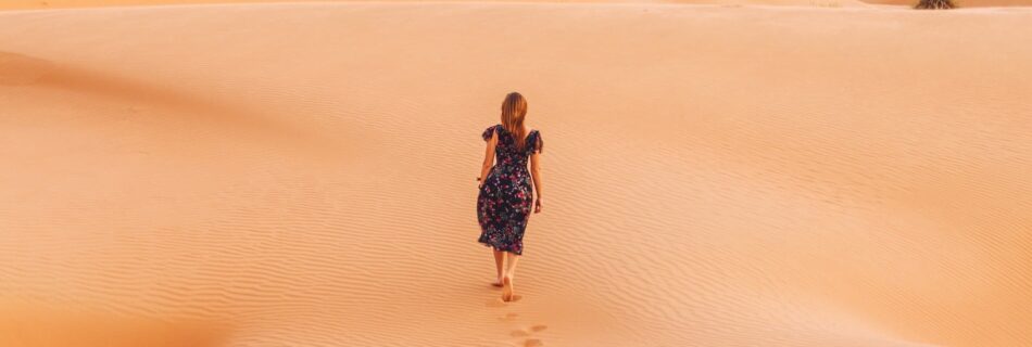 Desert with woman walking