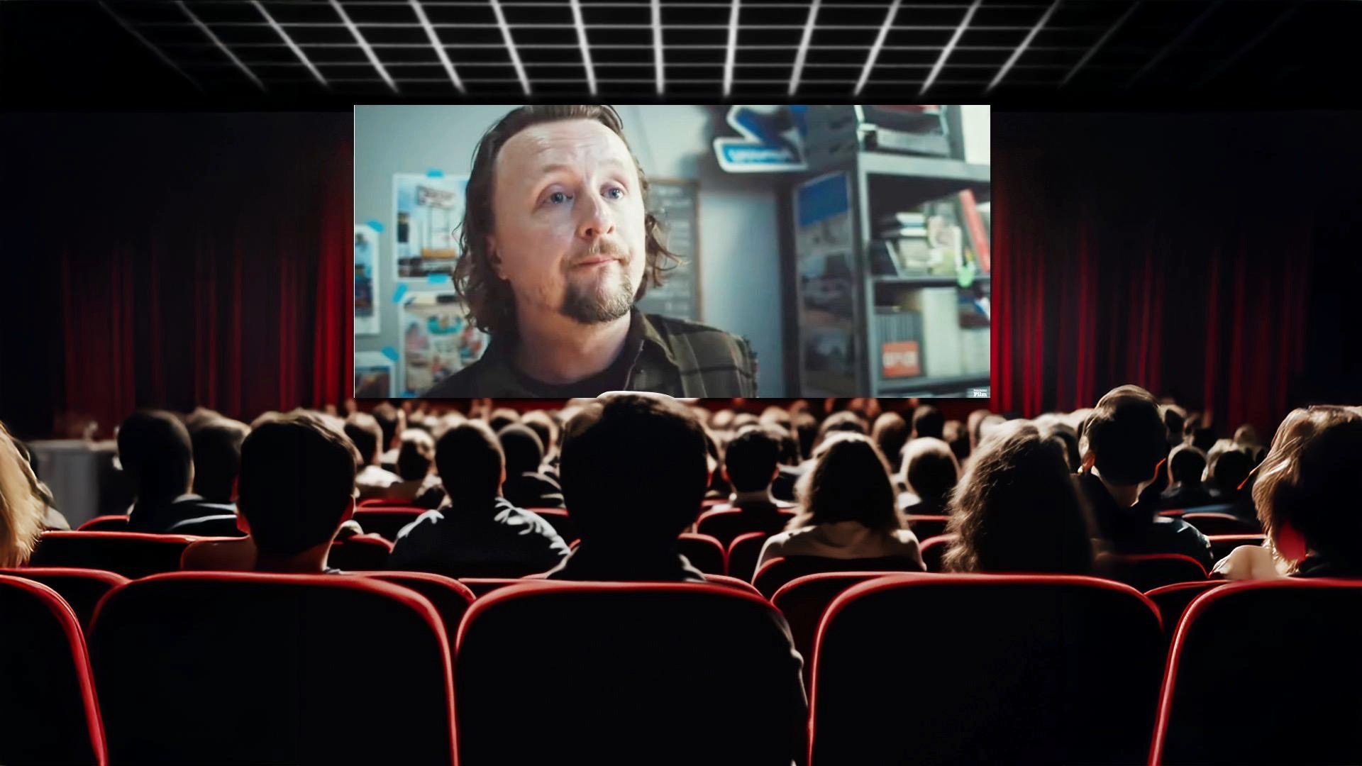 movie theater full of people looking up at the screen with actor Paul Cram's face from the movie "abroad"