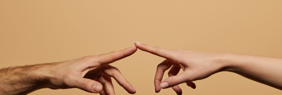 Two people's finger tips touching