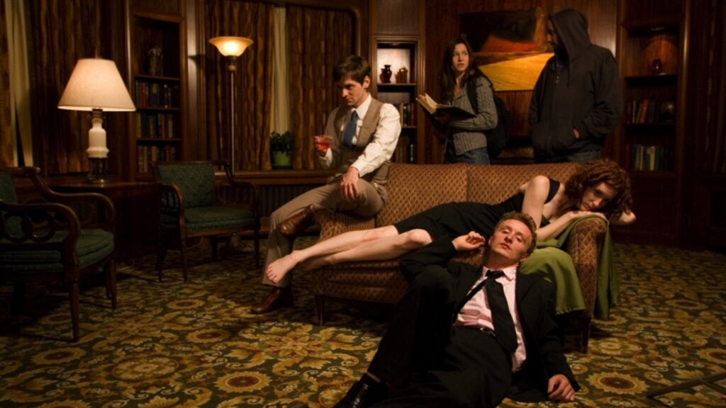 Actor Paul Cram lays on the floor beside Katrina Hawley, and Nathan, on the indie film "We Killed Alice"