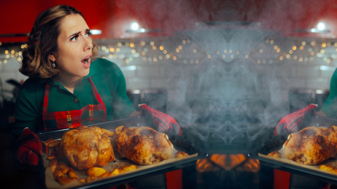 woman in kitchen with burnt holiday meal